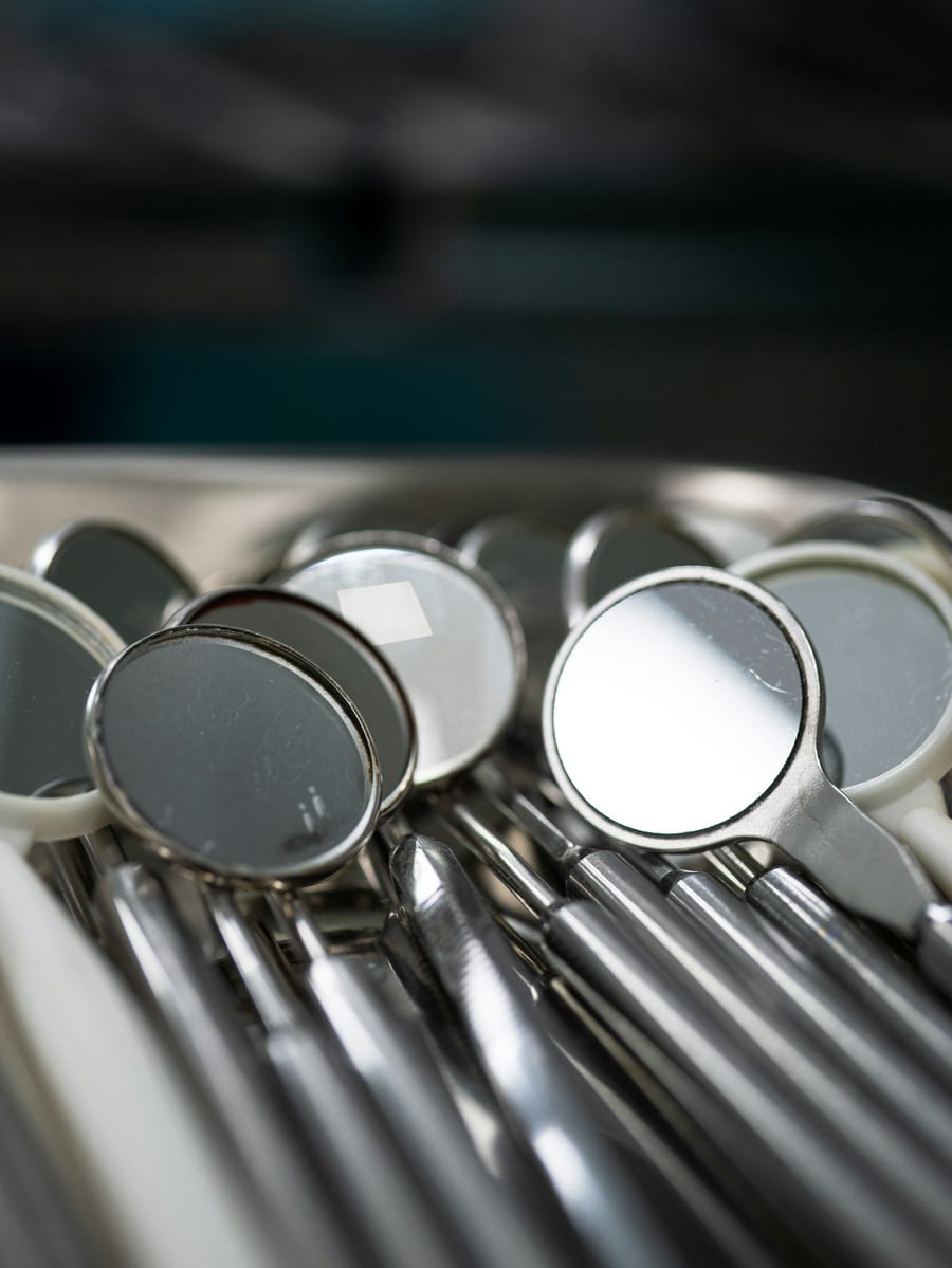 Dental mirrors and instruments laid out in a tray