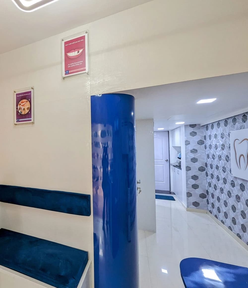 The waiting area with blue seating and a corridor to the treatment rooms